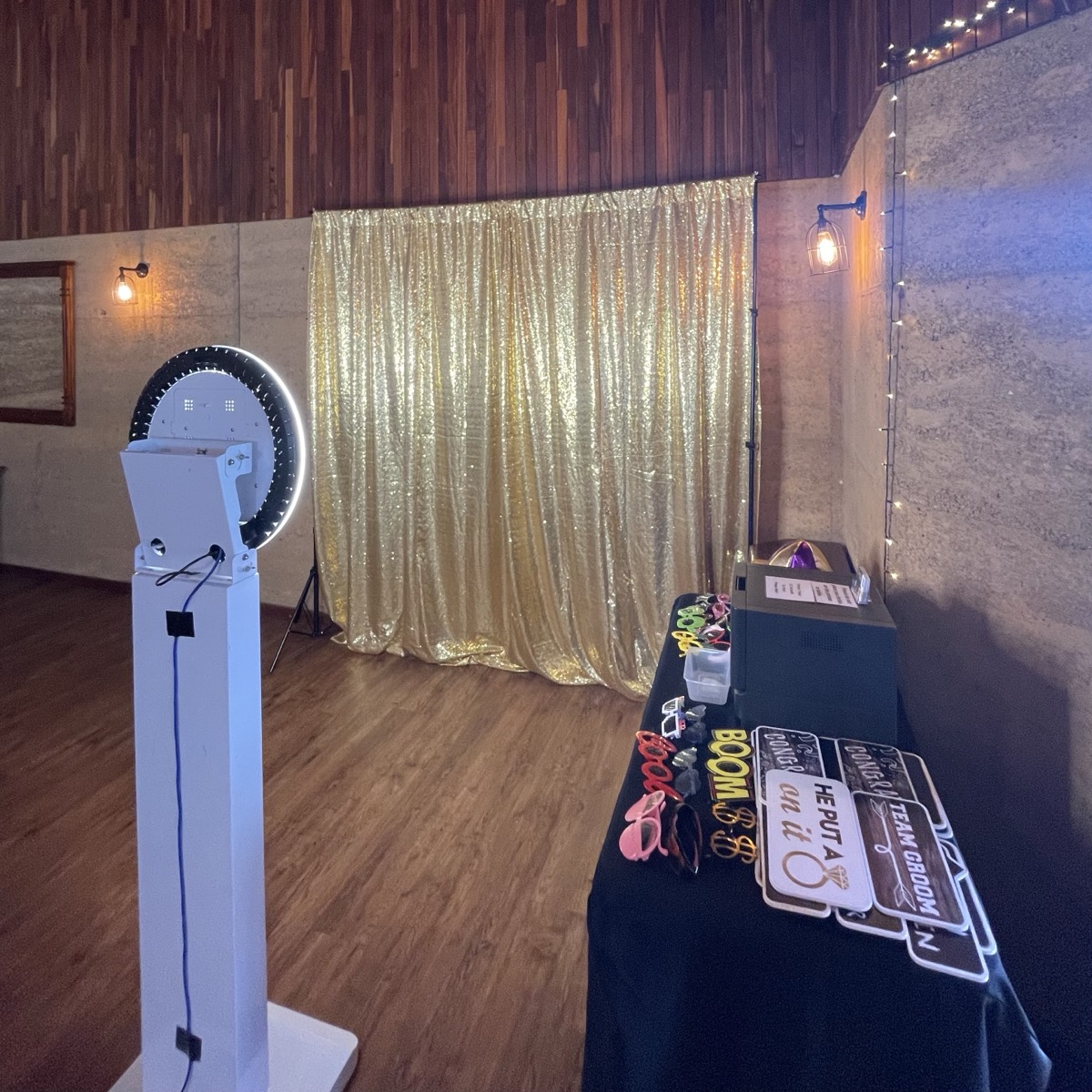 Photo booth with gold sequin backdrop and props set up in Perth